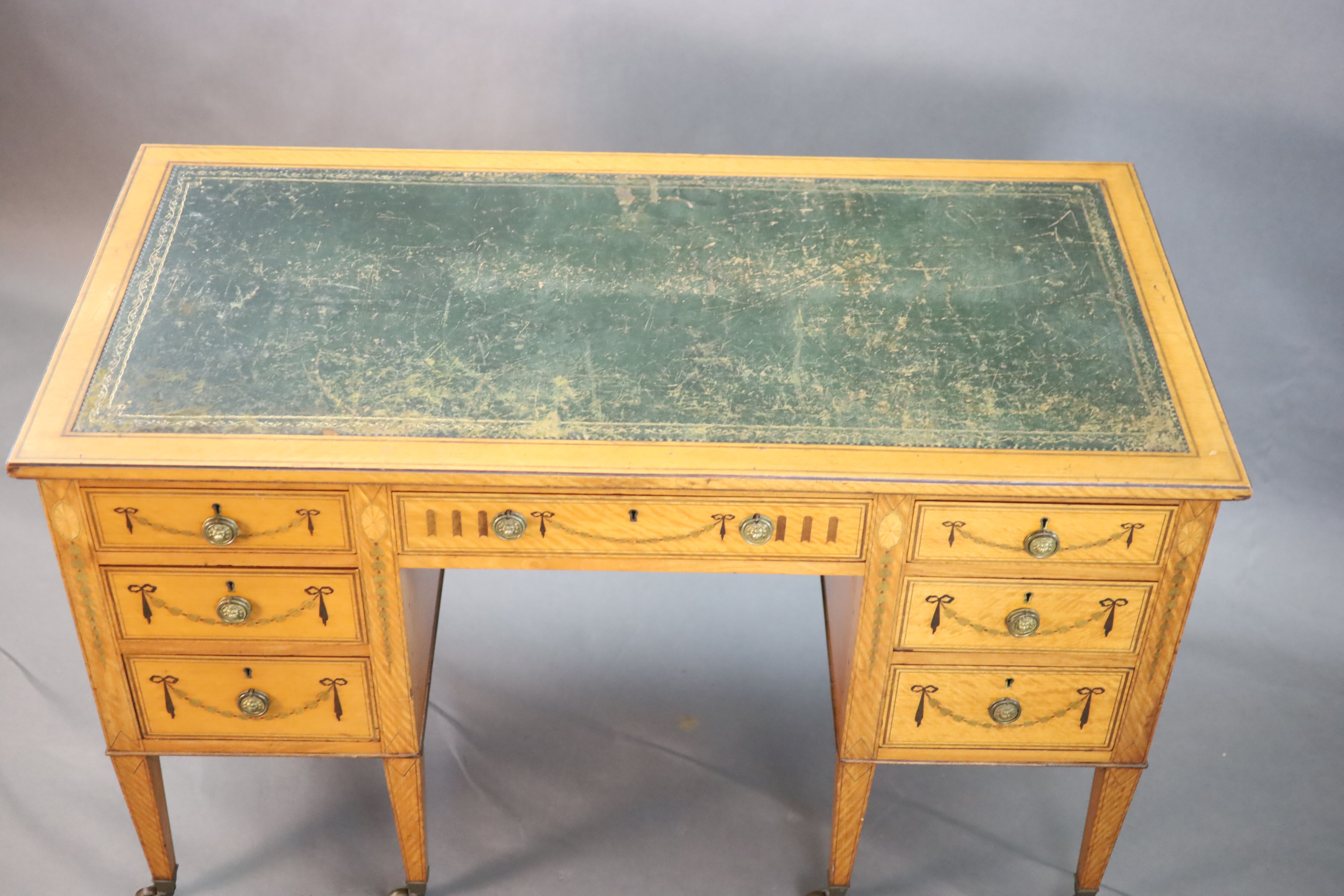 An Edwardian Edwards & Roberts marquetry inlaid satinwood kneehole desk, W.4ft D.2ft H.2ft 6in.